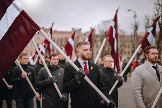 The youth leaders are carrying the Latvian flags in a procession on March 16, 2023, the Remembrance Day of the Latvian Legionnaires. The Latvian Legion was part of the Waffen SS. Photo: Jaunieši Latvijai